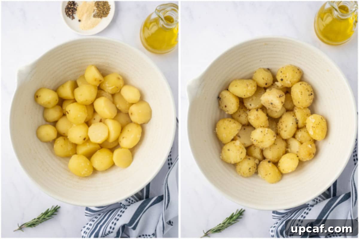 Drained and slightly smashed baby potatoes are being tossed with various seasonings in a bowl.