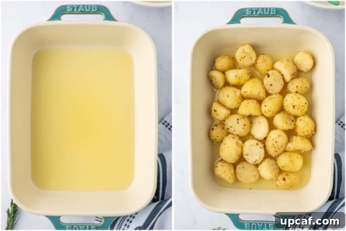 Seasoned baby potatoes are carefully being transferred into a hot baking dish with preheated olive oil.