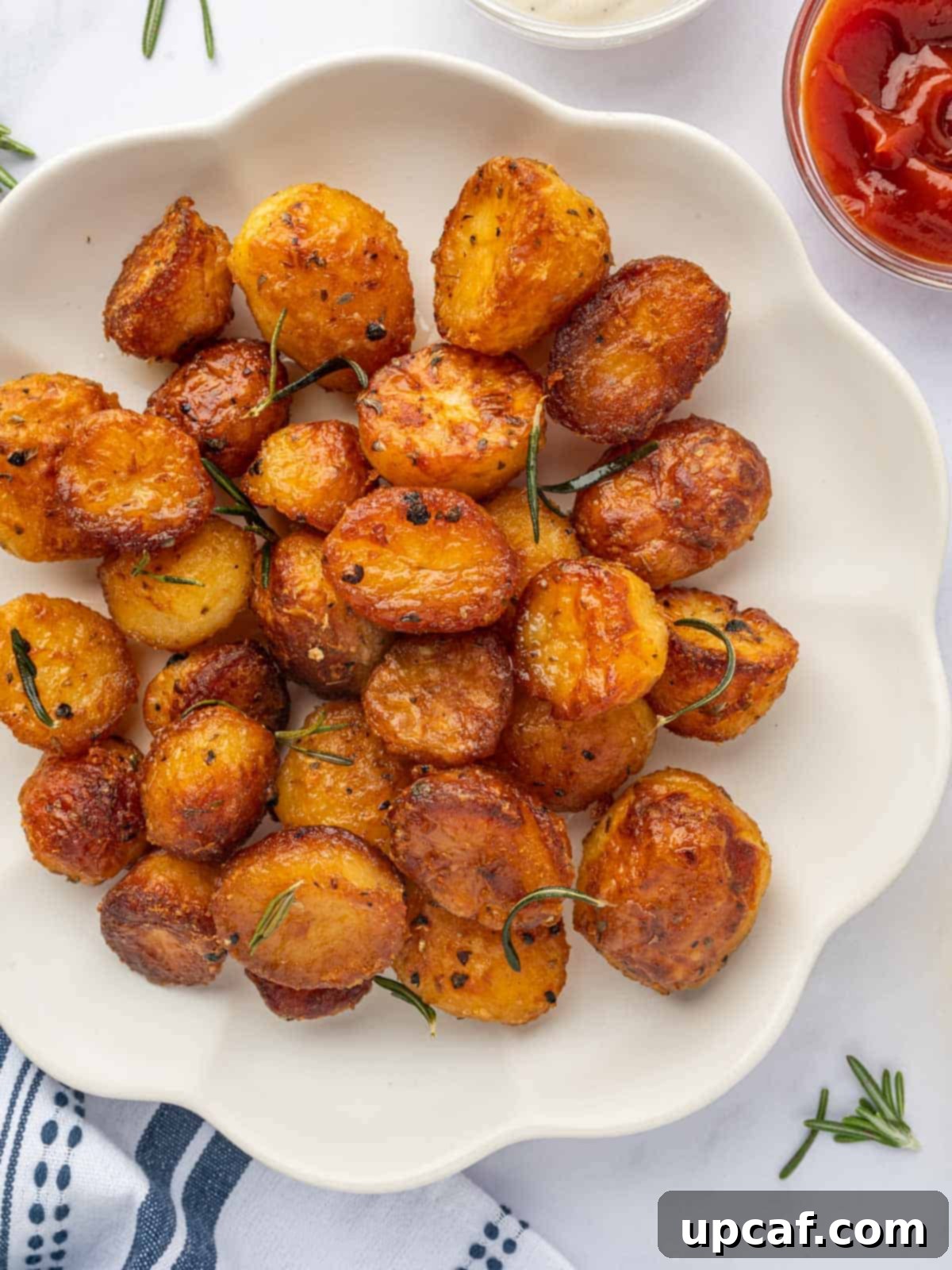 A white platter holding a generous portion of crunchy, golden baby potatoes, ready to be served.
