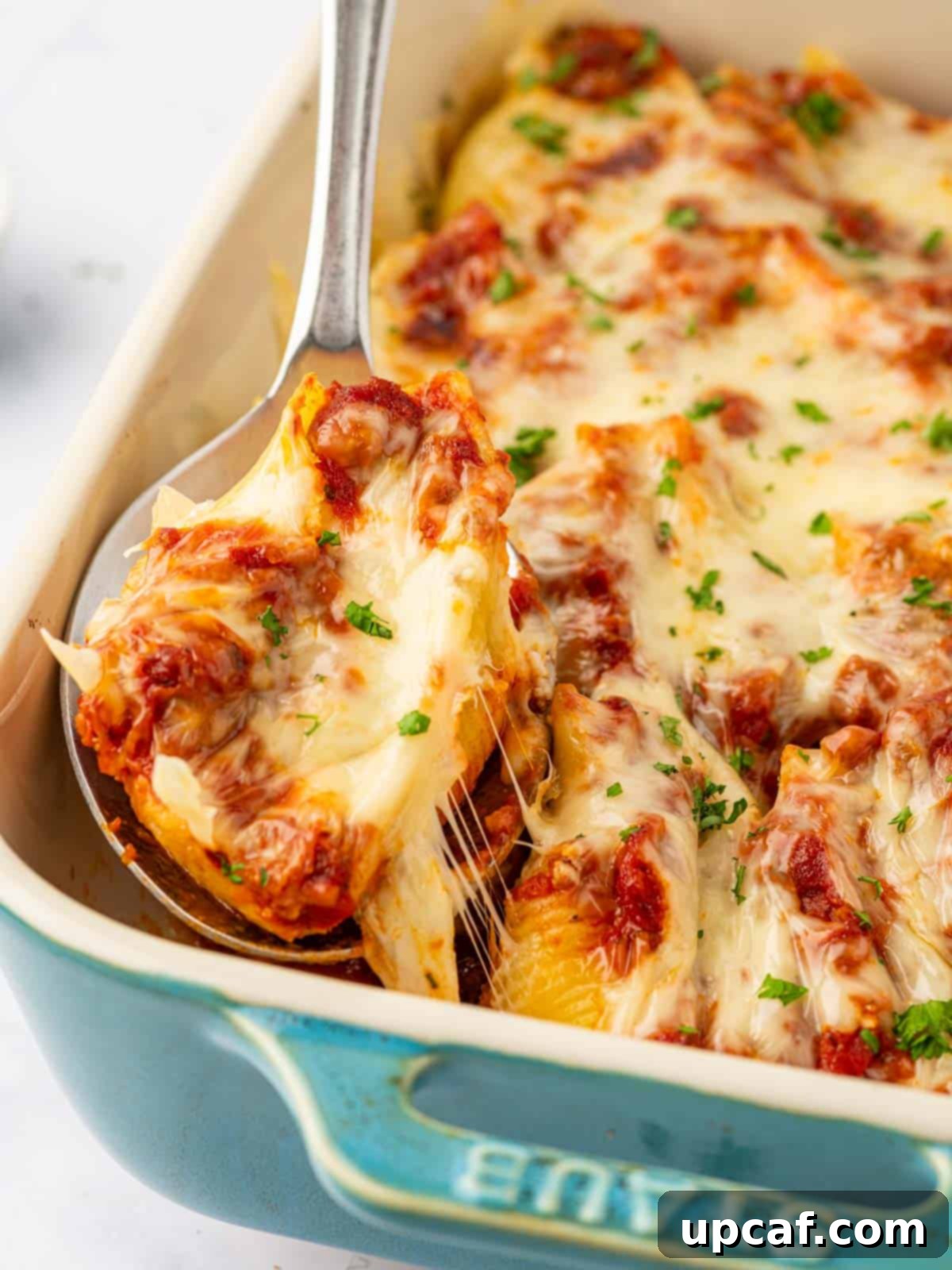 Hearty Beef and Ricotta Stuffed Shells 11 A spoonful of irresistible cheesy beef stuffed shells, showcasing the rich filling and melted mozzarella, ready to be enjoyed.