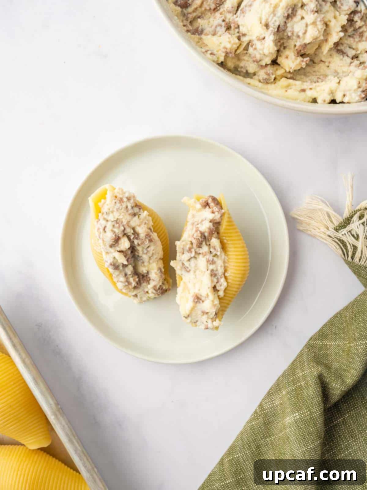 Hearty Beef and Ricotta Stuffed Shells 9 Cooked jumbo pasta shells carefully filled with the delectable beef and cheese mixture, ready for baking.