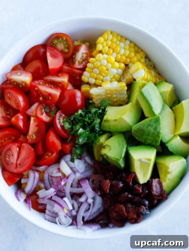 Ingredients for Avocado Corn Salad laid out on a board