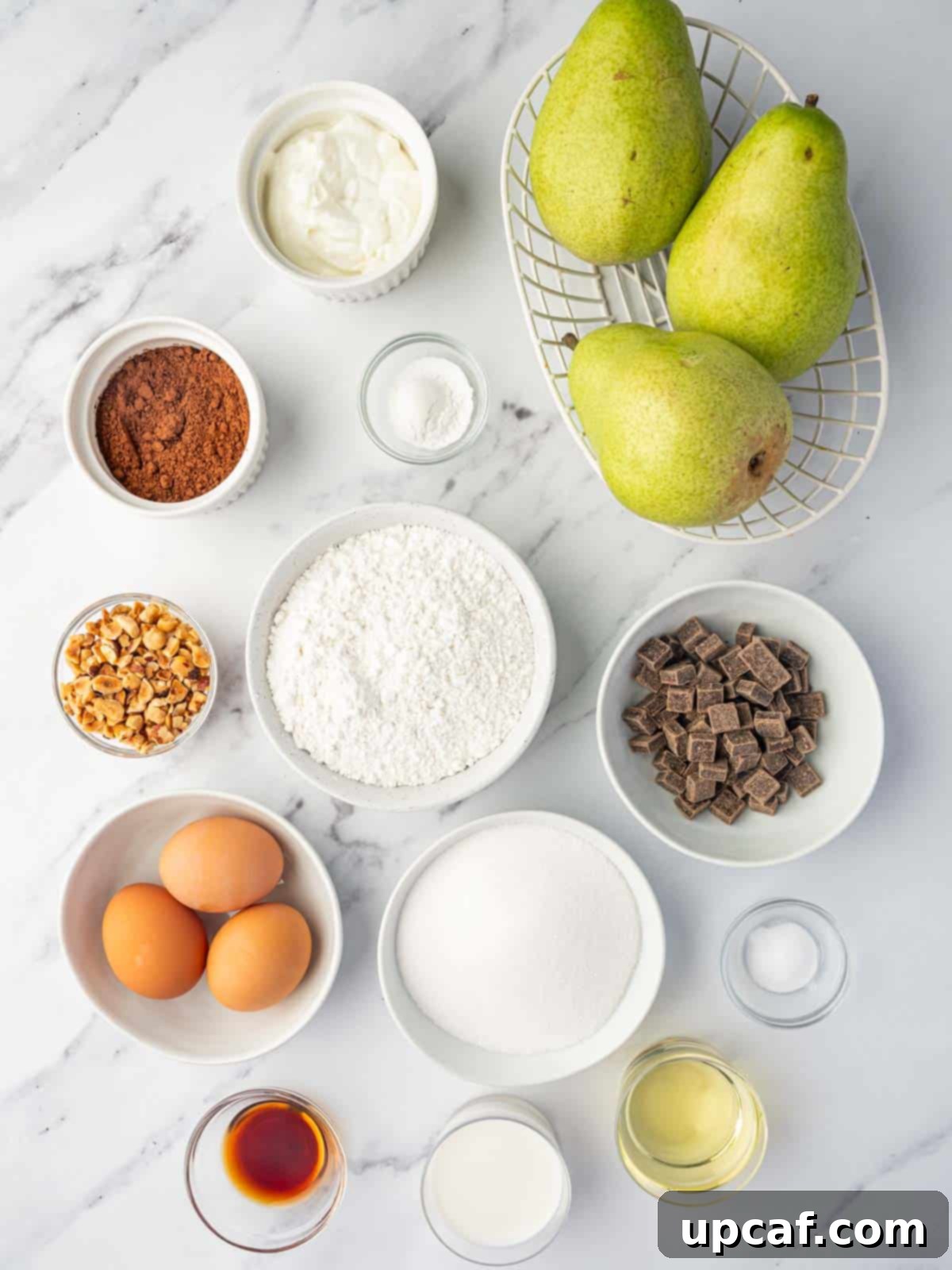 Chocolate Pear Bliss 3 Various ingredients for making chocolate pear cake, neatly laid out on a surface.