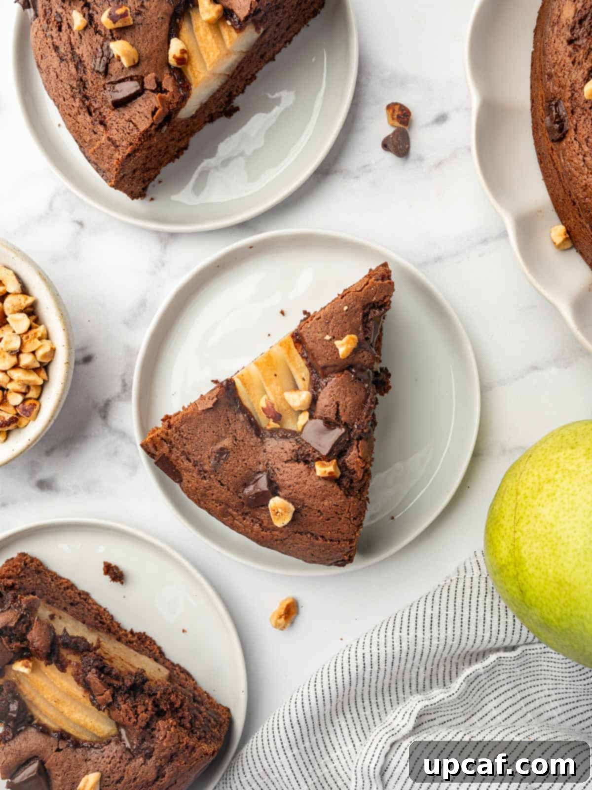 Chocolate Pear Bliss 10 Individual slices of chocolate pear cake on white plates, ready to be enjoyed.