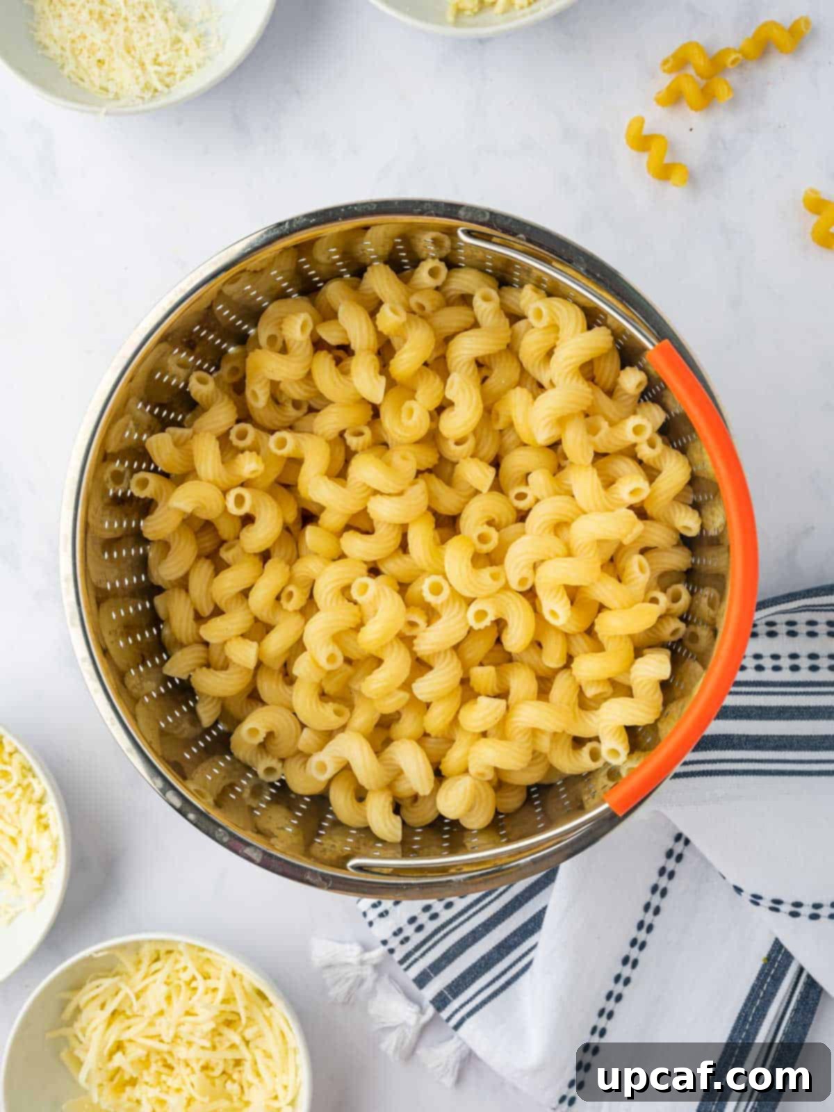 Cooked pasta in a strainer.