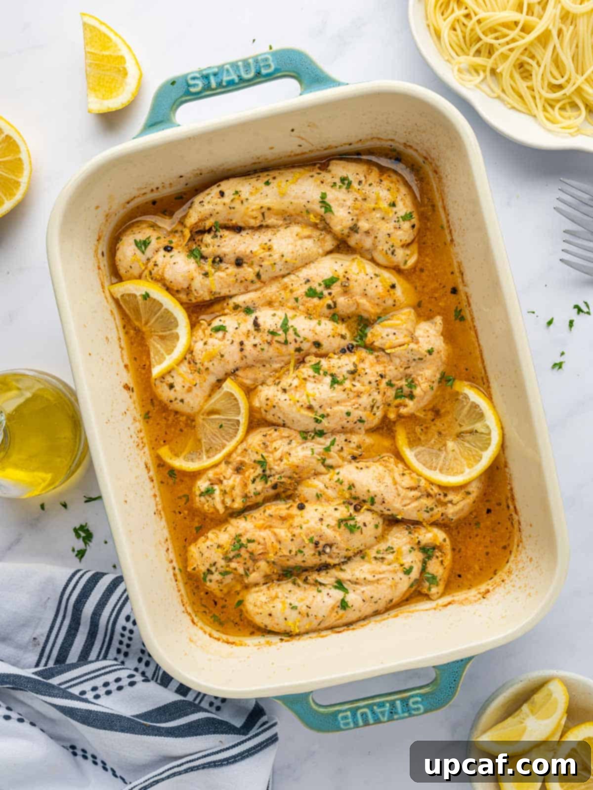 Baked lemon pepper chicken in a casserole dish.