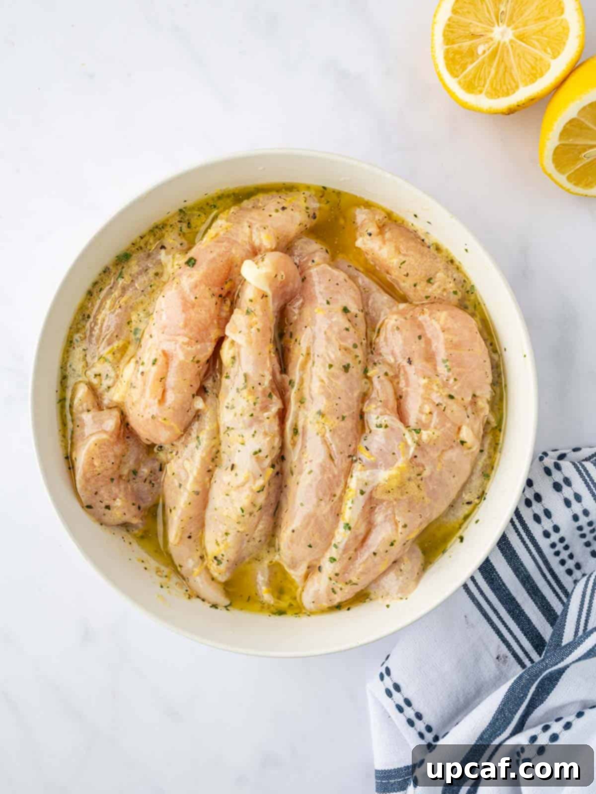 Chicken marinates in a lemon pepper seasoning blend.