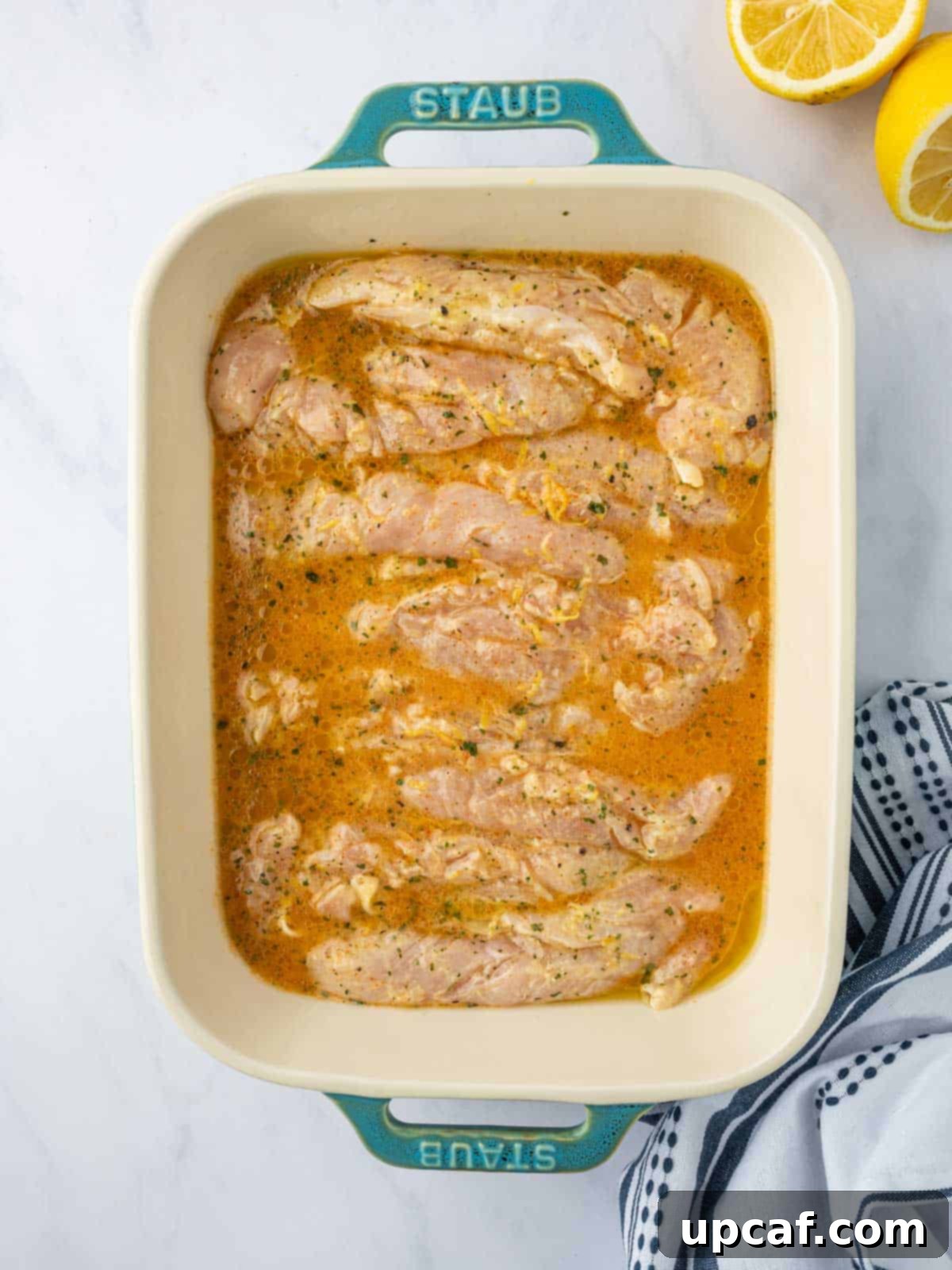 Chicken is prepared for baking.