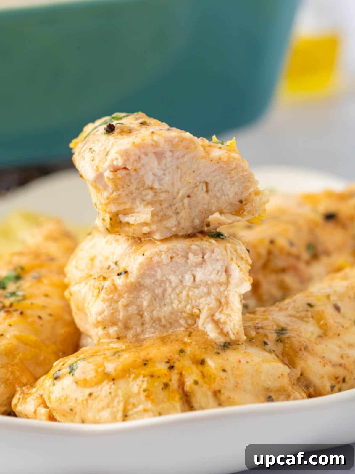 A juicy lemon pepper chicken tenders is sliced in half.