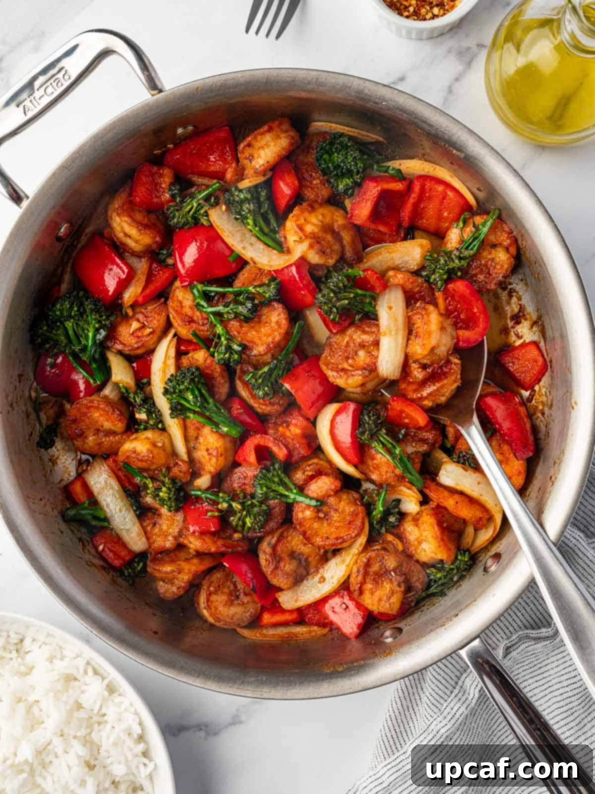 A vibrant skillet of homemade Panda Express Sizzling Shrimp, garnished with fresh herbs and ready to serve.
