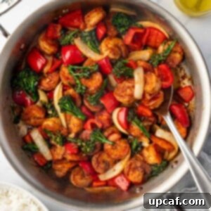 Panda express shrimp in a skillet with a spoon.