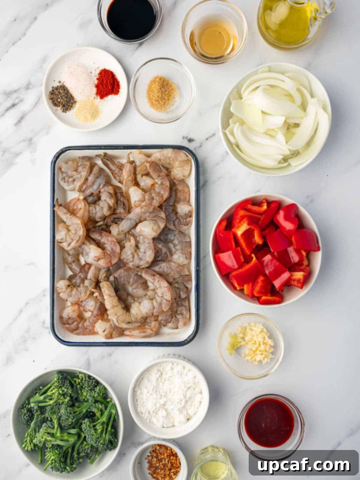 Individual ingredients for Panda Express Sizzling Shrimp laid out on a cutting board.