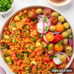 Bowl of Turkish Kisir Salad garnished with fresh tomatoes, black olives, and thinly sliced radish, beautifully presented for serving.