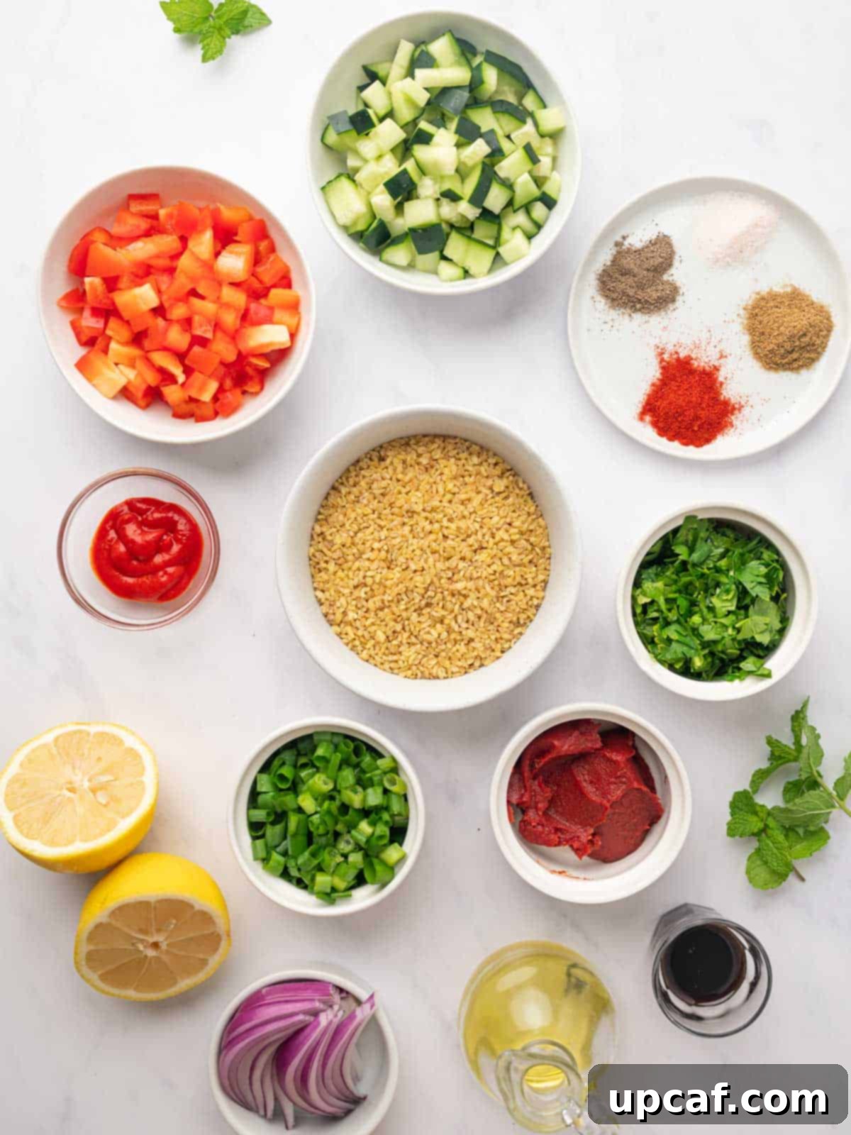 Ingredients for Turkish bulgur salad (Kisir) meticulously laid out on a countertop, including bulgur, fresh vegetables, herbs, and various dressing components.