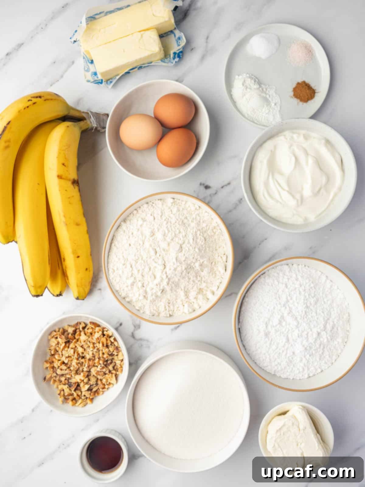 A flat lay of all the fresh and dry ingredients meticulously arranged for baking a delicious banana walnut cake.
