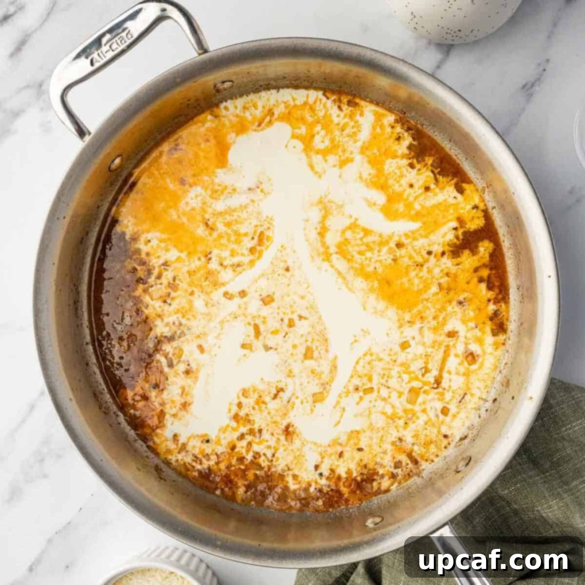 Preparing the creamy lemon-butter sauce in a skillet.