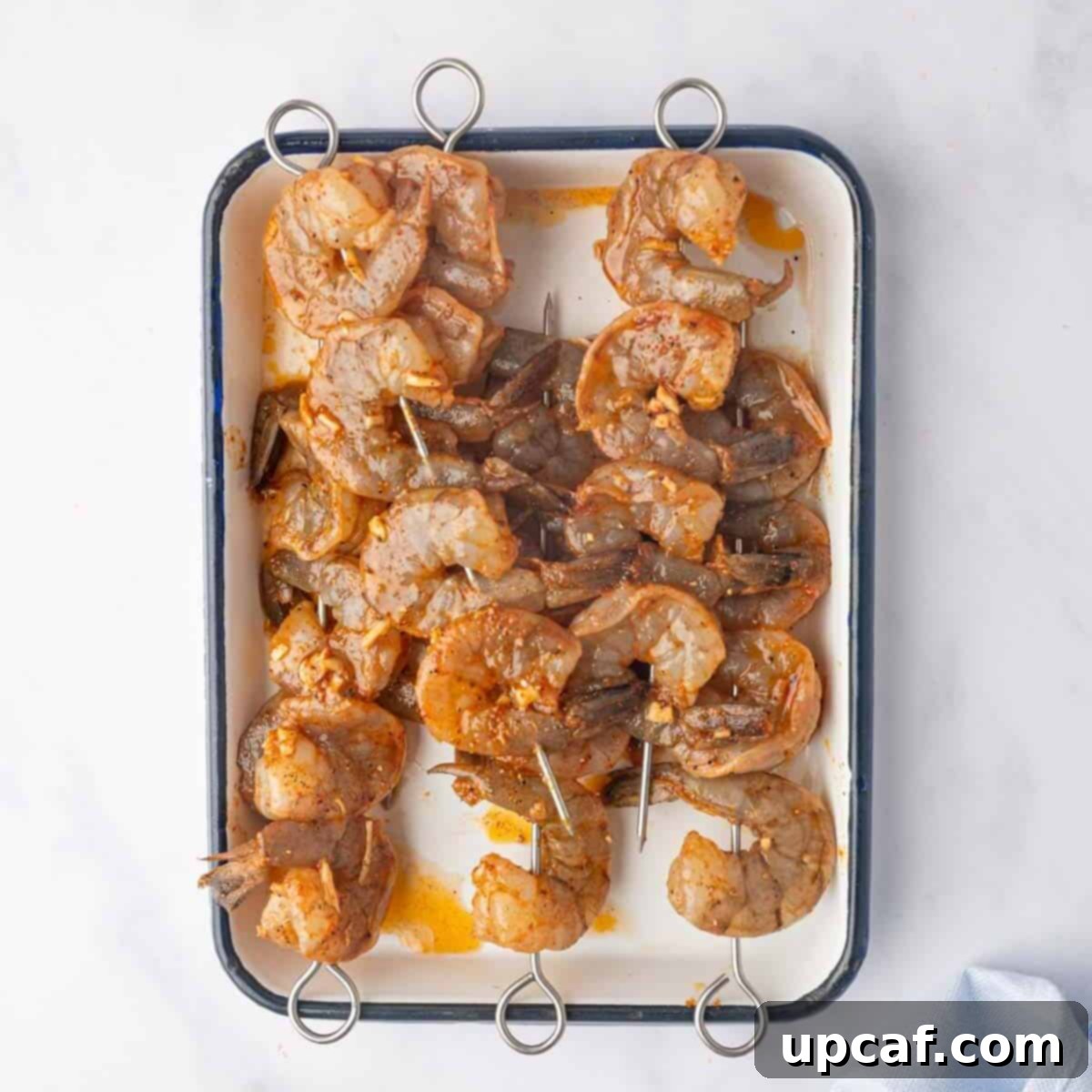Fiery Cajun Grilled Shrimp 6 Marinated shrimp are threaded onto skewers.