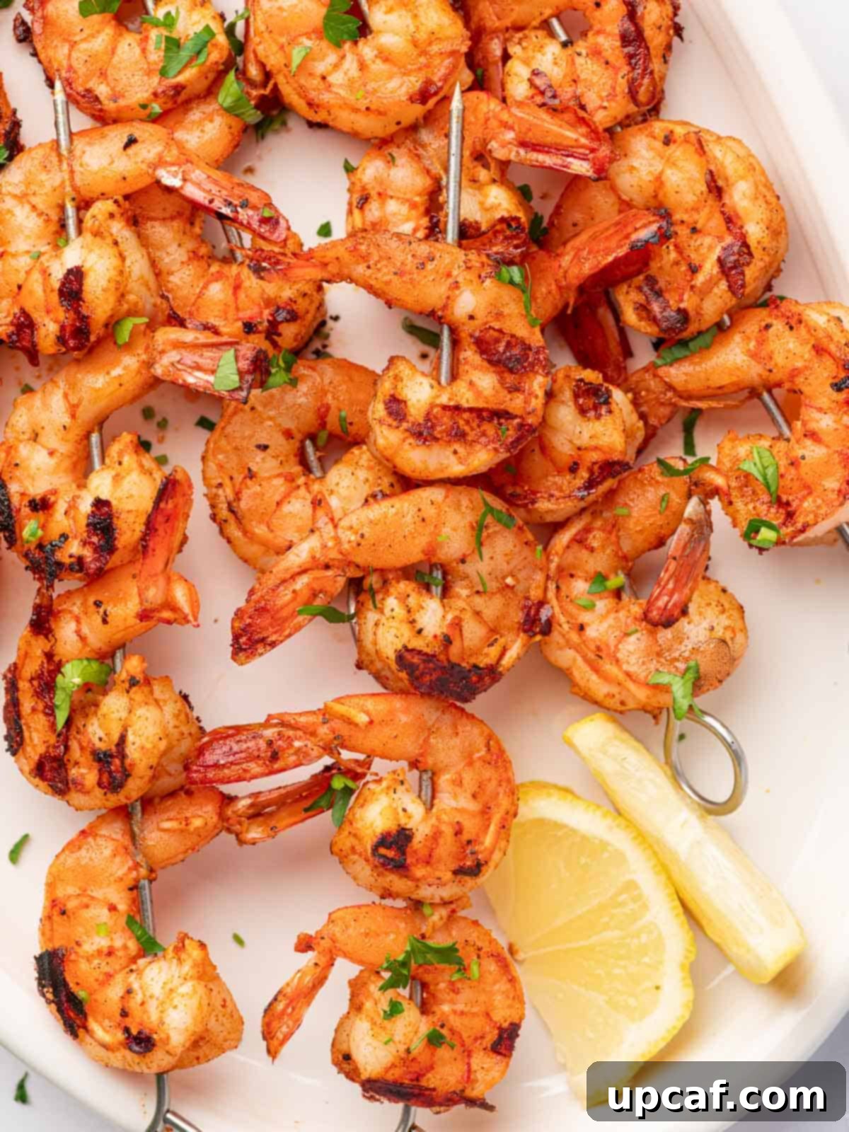 Fiery Cajun Grilled Shrimp 8 Grilled cajun shrimp skewers piled on a platter.