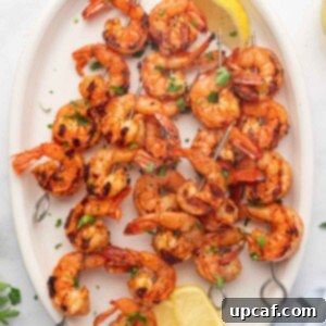 Fiery Cajun Grilled Shrimp 9 A platter with lemon wedges and grilled cajun shrimp skewers.