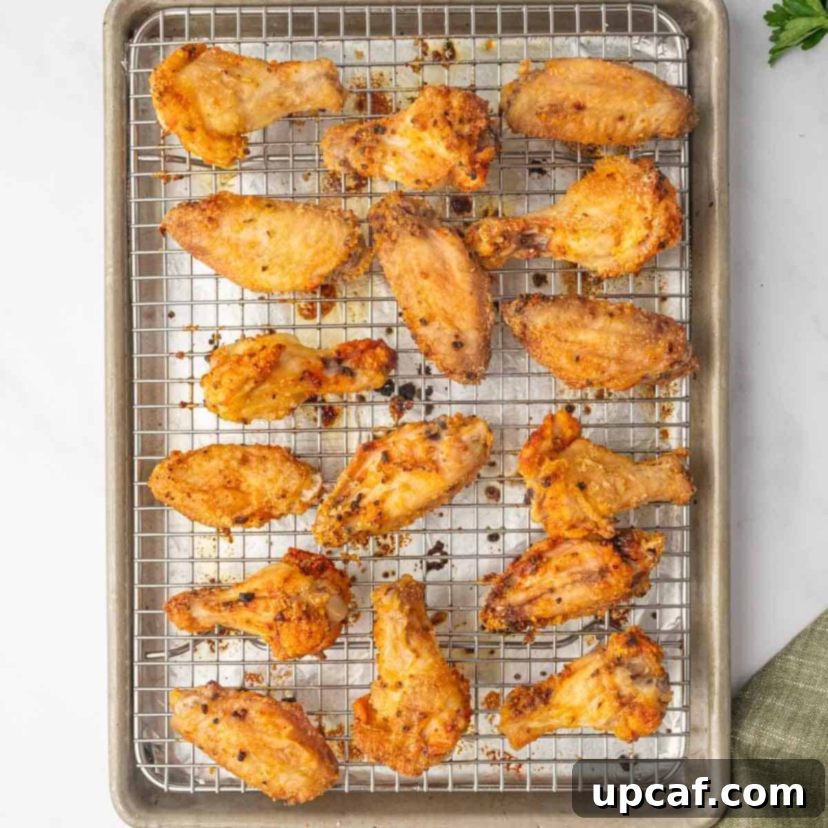 Honey-Glazed Lemon Pepper Wings 5 Baked honey lemon pepper chicken wings on a rack.