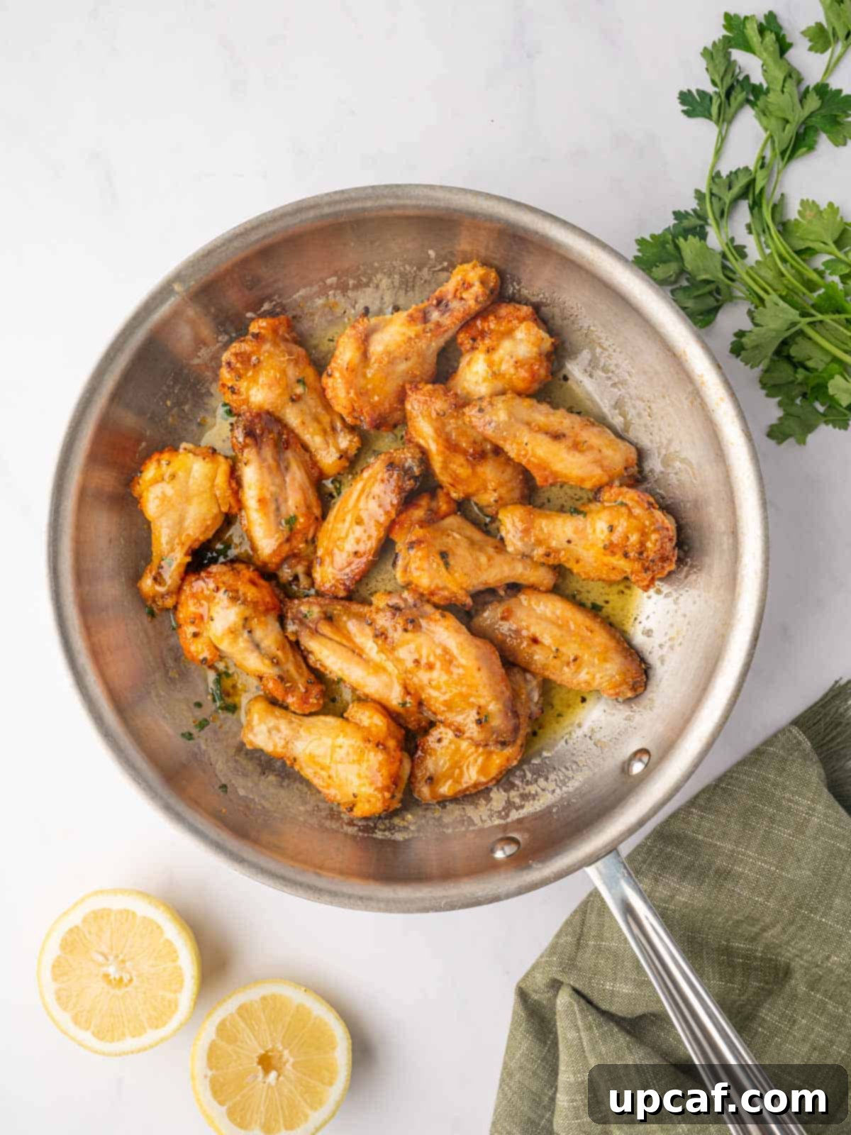 Honey-Glazed Lemon Pepper Wings 8 Honey Lemon Pepper Wings in a skillet.