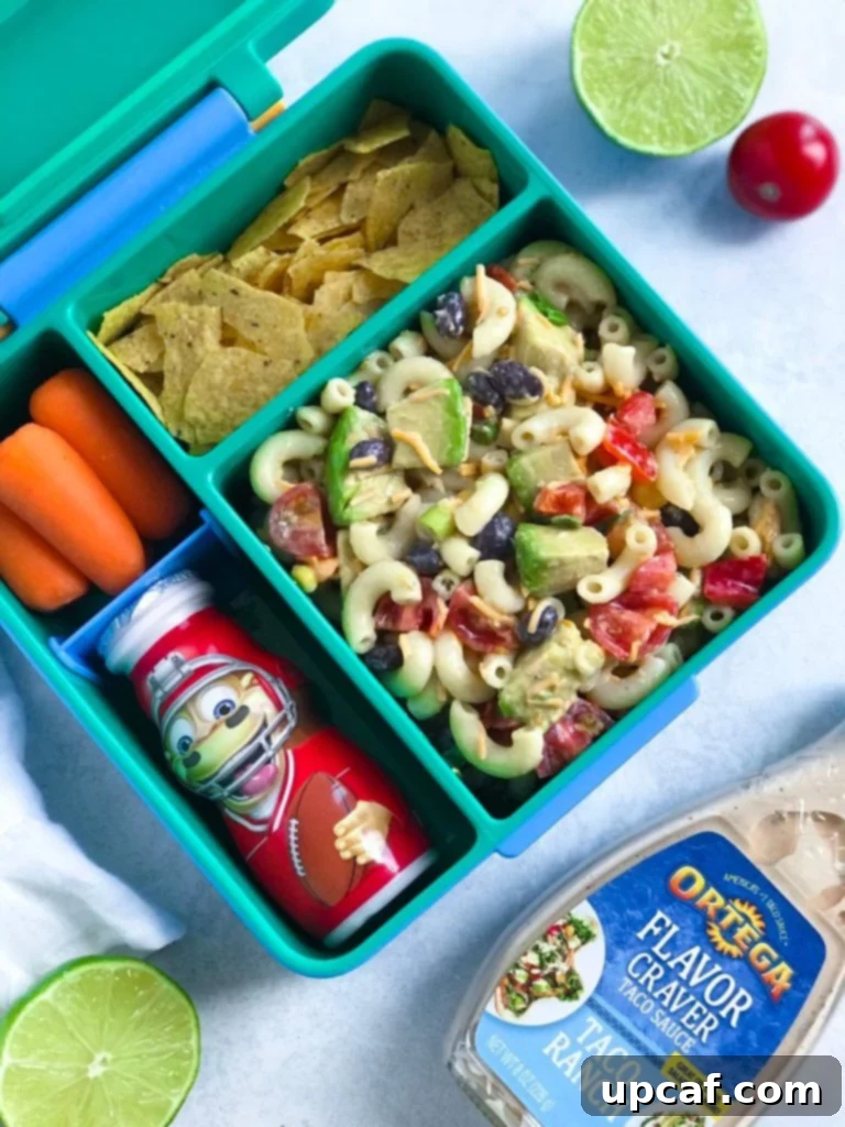 Taco Ranch Pasta Salad packed neatly in a kid's lunchbox alongside other snacks, ready for school.