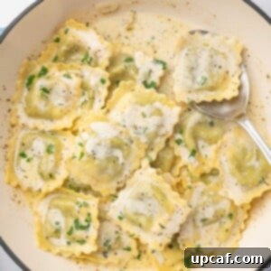 A spoon serves a piece of ravioli from a dutch oven.