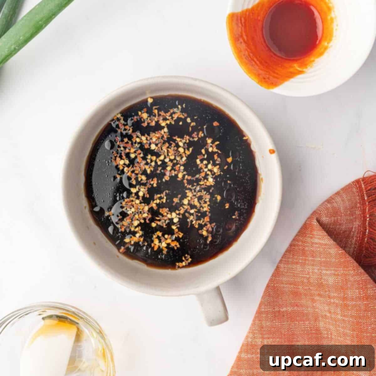 A bowl containing the mixed honey chili sauce ingredients, ready to be cooked.