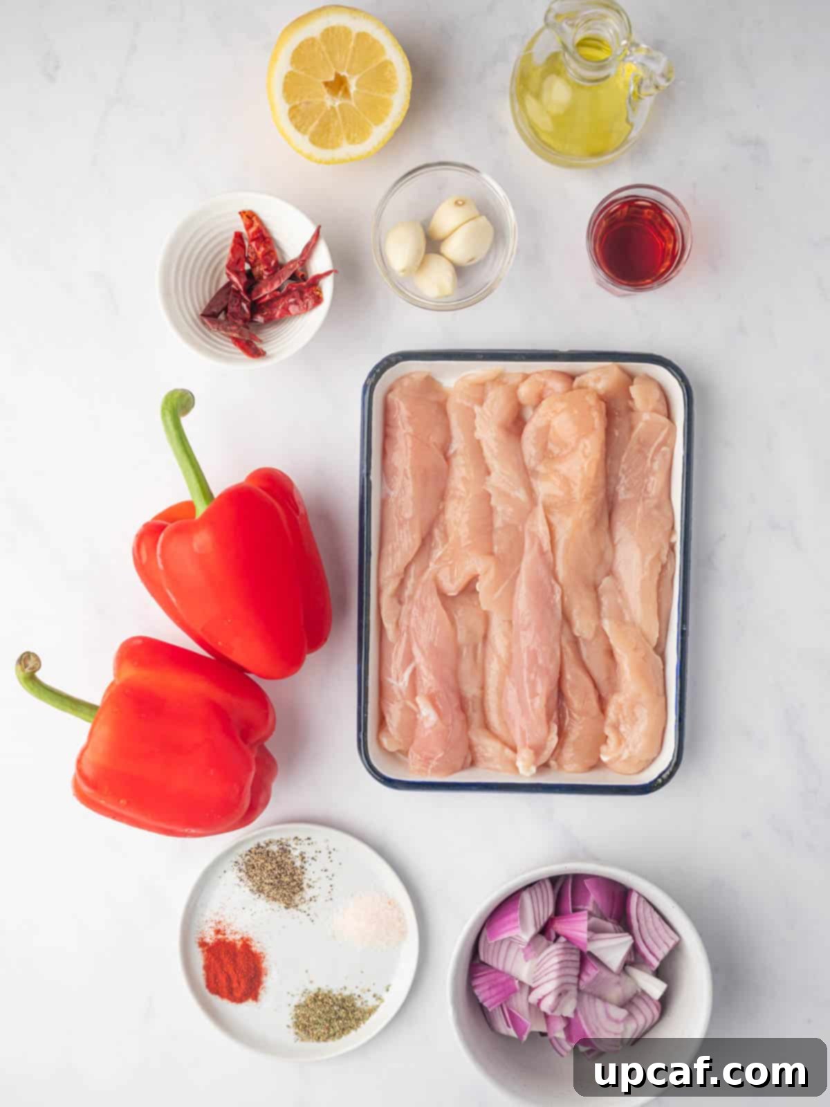 Fiery Peri Peri Chicken 3 A selection of fresh ingredients laid out for making grilled peri peri chicken, including peppers, chilis, and garlic.