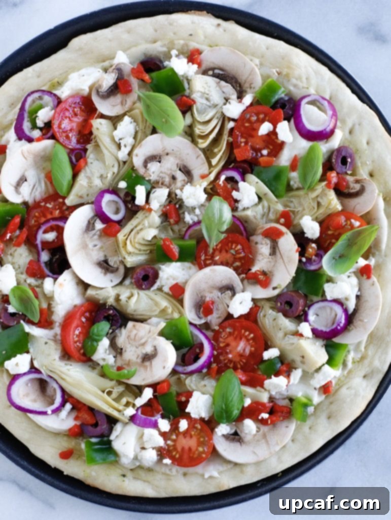 Mediterranean Harvest Pizza 4 Top down shot of Mediterranean Veggie Pizza, ready to be baked