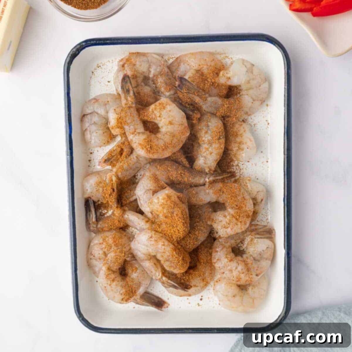 One Love Shrimp Pasta 4 Raw shrimp generously coated with jerk seasoning blend in a bowl, ready for cooking.