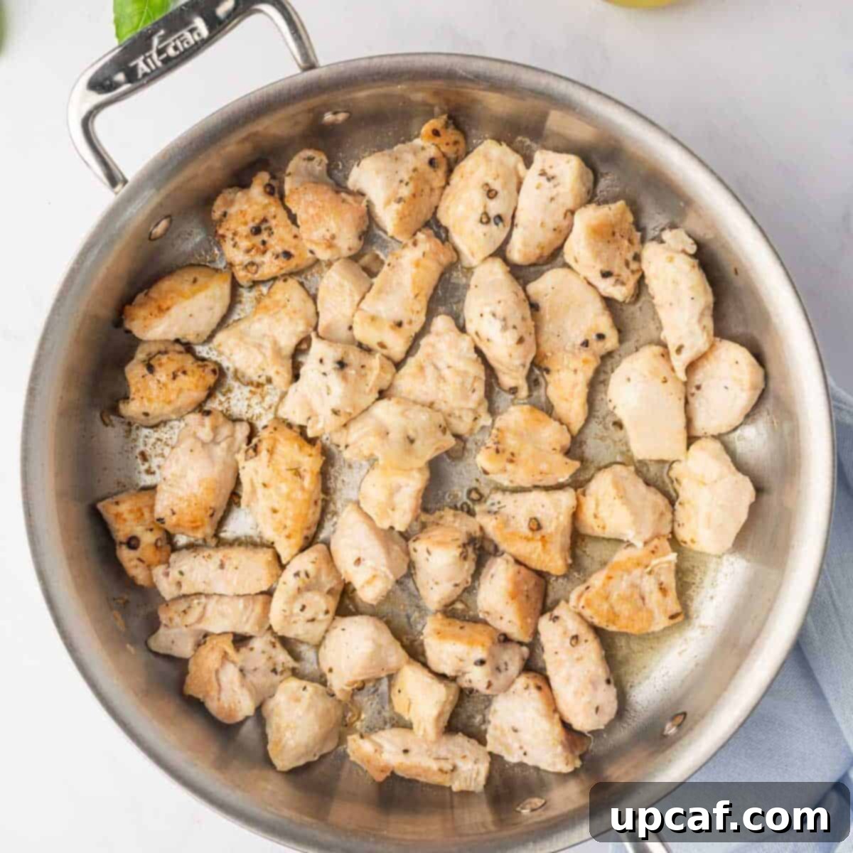 Chicken cooked to a golden brown in a skillet.