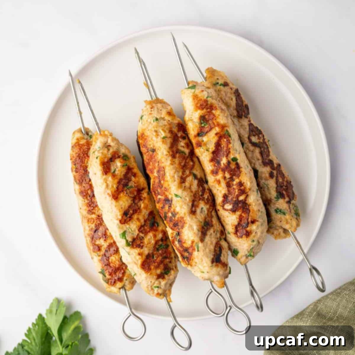 Perfectly Spiced Chicken Kofta 7 A platter displaying freshly grilled chicken kofta skewers, perfectly charred and ready to be served.