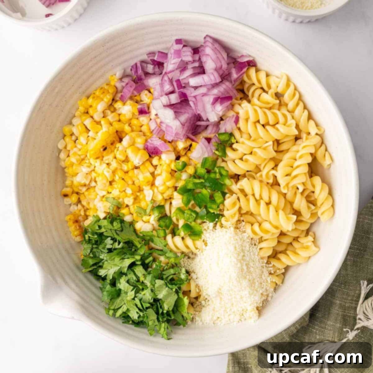 Combining salad ingredients in a bowl.