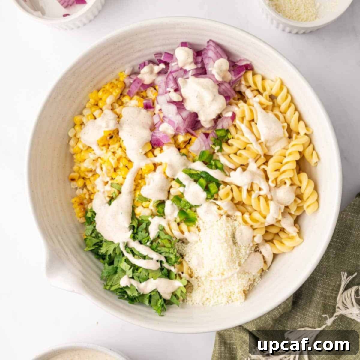 Drizzle the pasta salad with dressing.