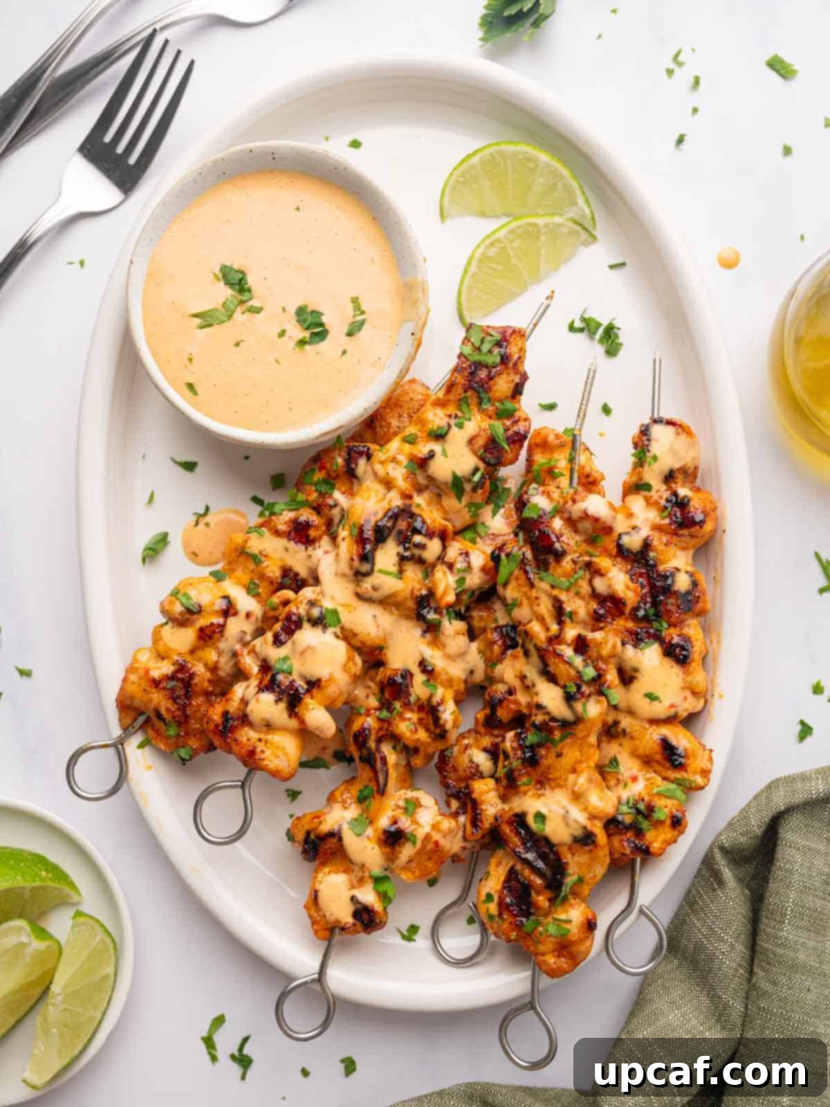 Dynamite Chicken Skewers 2 Vibrant Bang Bang chicken skewers artfully arranged on a platter, ready to be served.