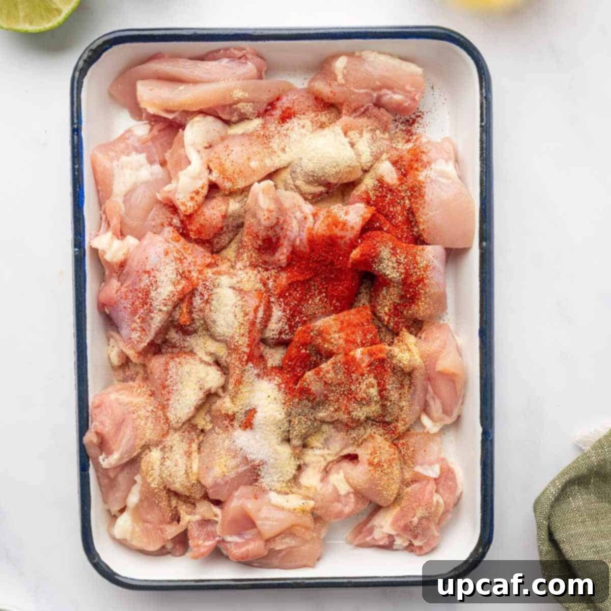 Dynamite Chicken Skewers 4 Seasoned chicken thigh cubes on a platter, ready for skewering.