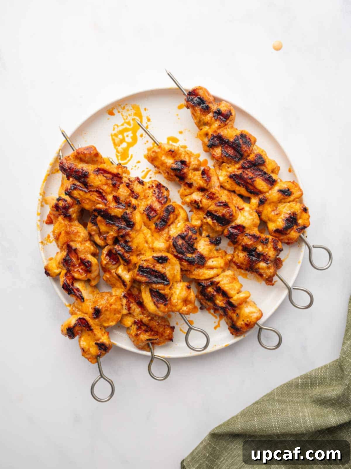 Dynamite Chicken Skewers 8 A plate of freshly grilled Bang Bang Chicken Skewers, beautifully plated.