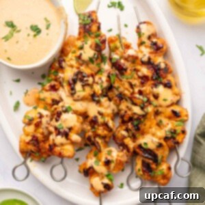 Dynamite Chicken Skewers 10 A platter of beautifully grilled Bang Bang chicken skewers, garnished and ready to serve.