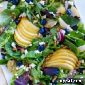 fall salad on a white plate. A delicious and fresh Autumn Pear Salad.