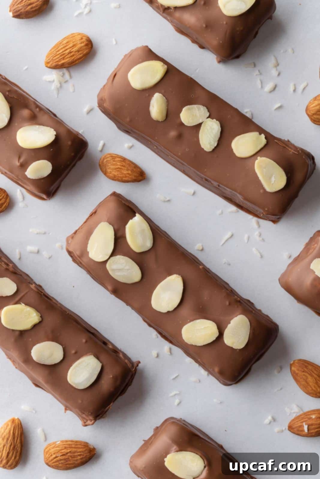 Island Coconut Chocolate Dream 2 Candy bars topped with almonds on a tray, showcasing their delicious appearance.