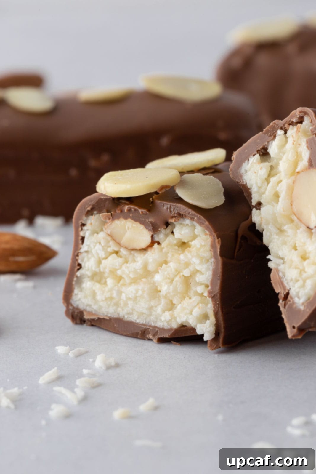 Island Coconut Chocolate Dream 11 A close-up of a cut candy bar reveals the luscious coconut almond filling inside the chocolate coating.