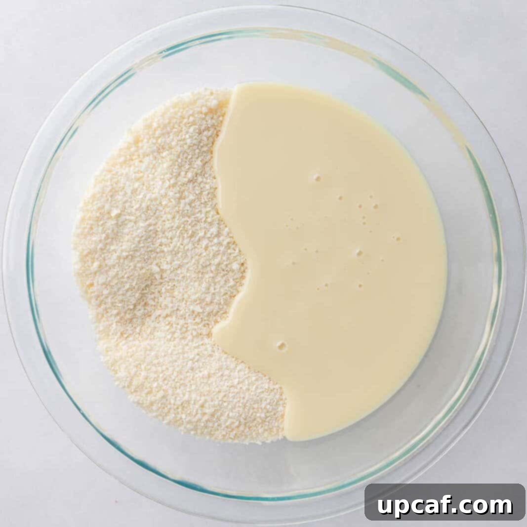 Island Coconut Chocolate Dream 4 Coconut and condensed milk are mixed together in a large bowl to form the chewy filling.