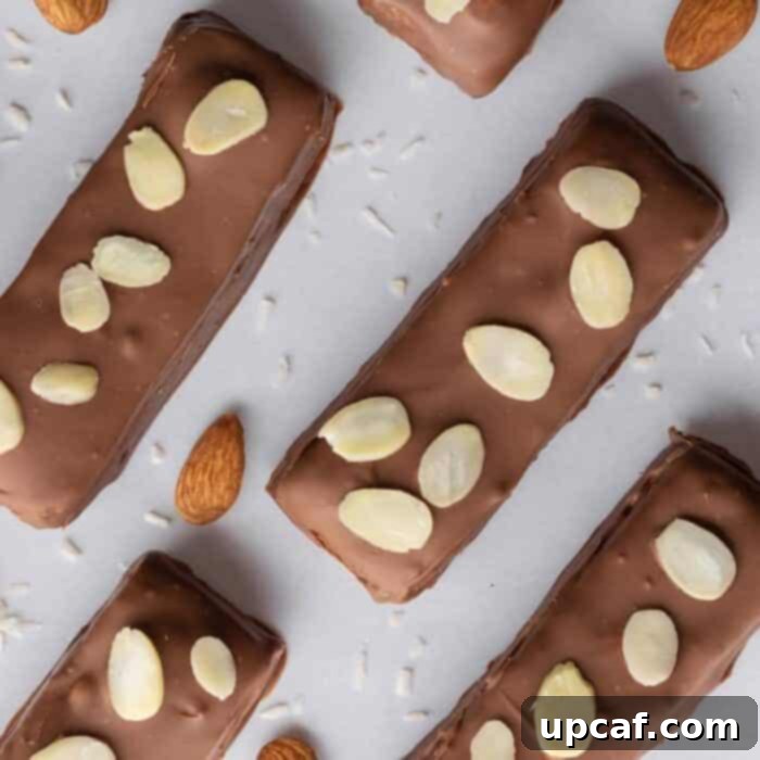 Island Coconut Chocolate Dream 9 Finished candy bars, still wet with chocolate, are garnished with slivered almonds before setting.