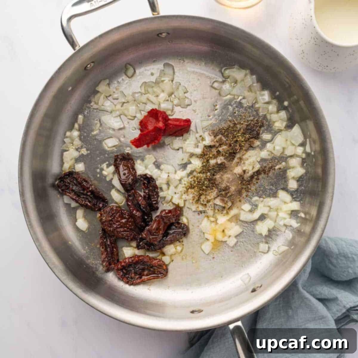 Decadent Lobster Ravioli Sauce 5 Lobster sauce ingredients are sauteed in a pan.