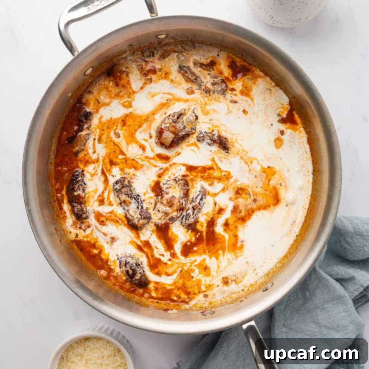 Decadent Lobster Ravioli Sauce 6 Sun dried tomatoes are mixed with cream to make sauce for lobster ravioli.