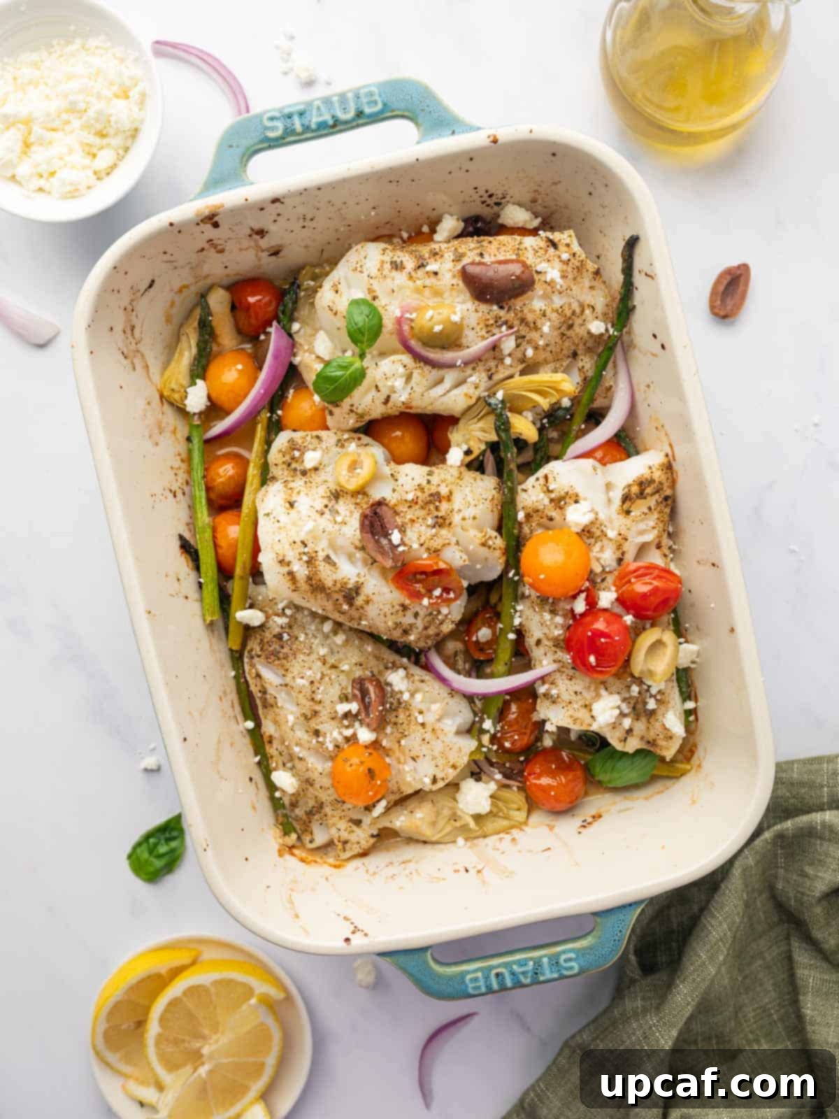 Mediterranean cod with vegetables in a baking dish.
