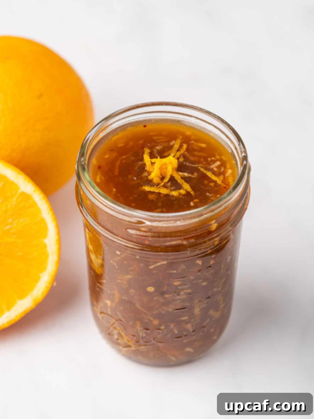 Easy homemade orange chicken sauce in a glass jar, ready to be used or stored.