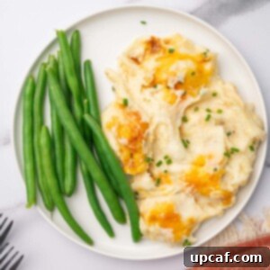 Decadent Cheesy Mash 12 Cheesy potatoes and green beans on a serving plate.