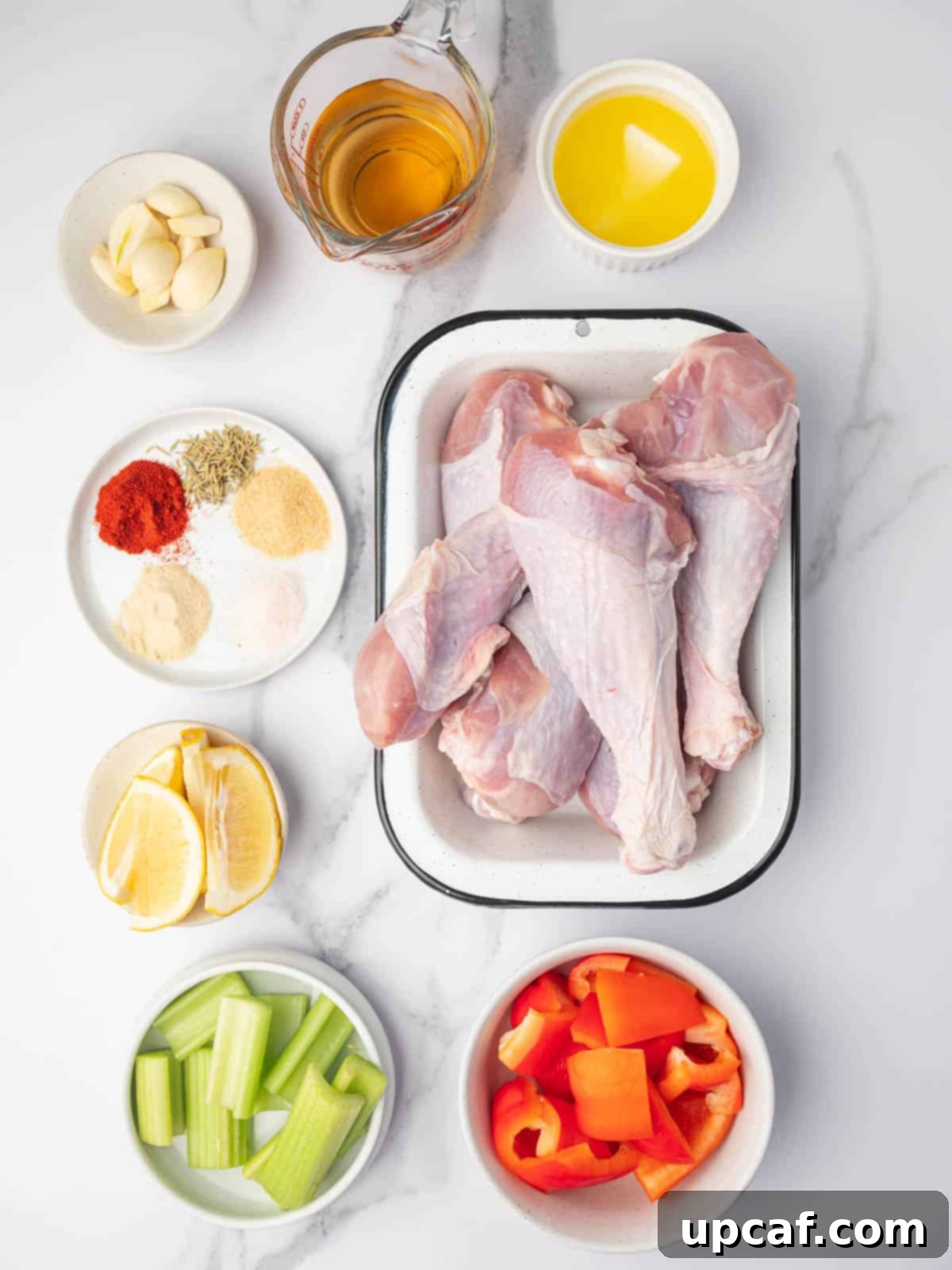 Ingredients needed for turkey drumsticks including fresh vegetables and spices.